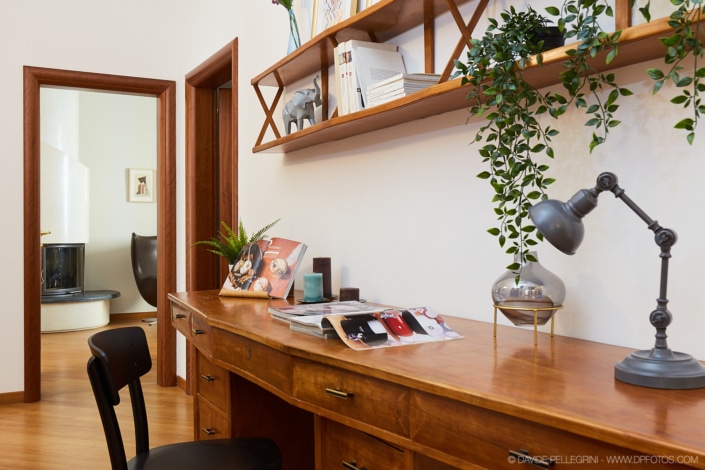 Un escritorio de madera con una lámpara, perfecto para interiorismo.