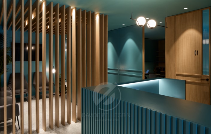 Un reportaje fotográfico de una clínica moderna con paredes azules y paneles de madera.