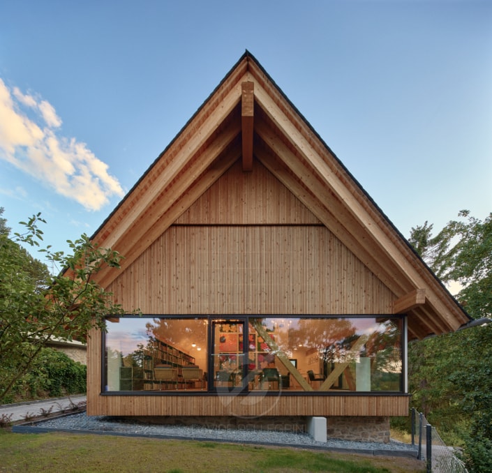 Un reportaje fotográfico de arquitectura de una casa de madera con techo de pizarra.